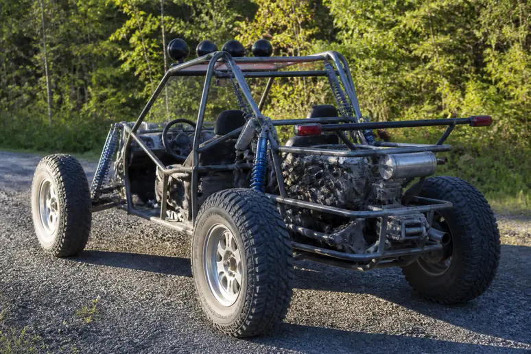 Buggy léger et ouvert stationné sur un chemin en terre battue